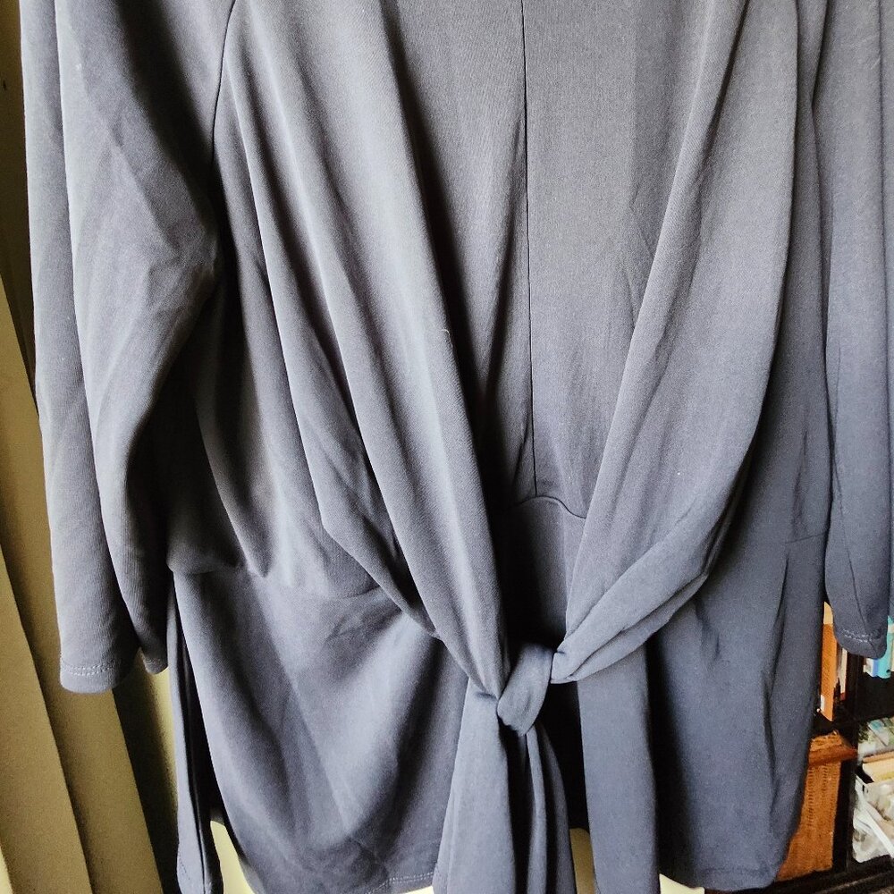 Unique black peplu, top with front draping tie